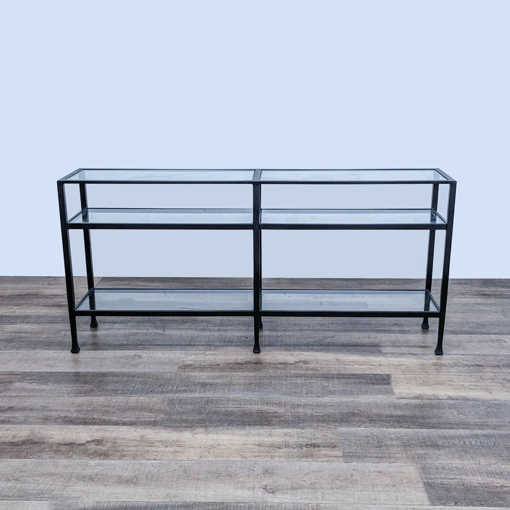 Wrought iron console table with tempered glass shelves in blackened bronze finish.
