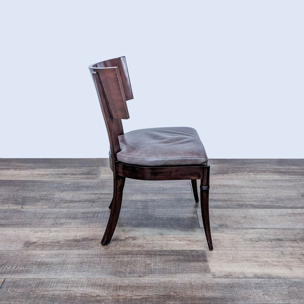 Side view of the Williams Sonoma Home dining chair with wood back and leather seat.