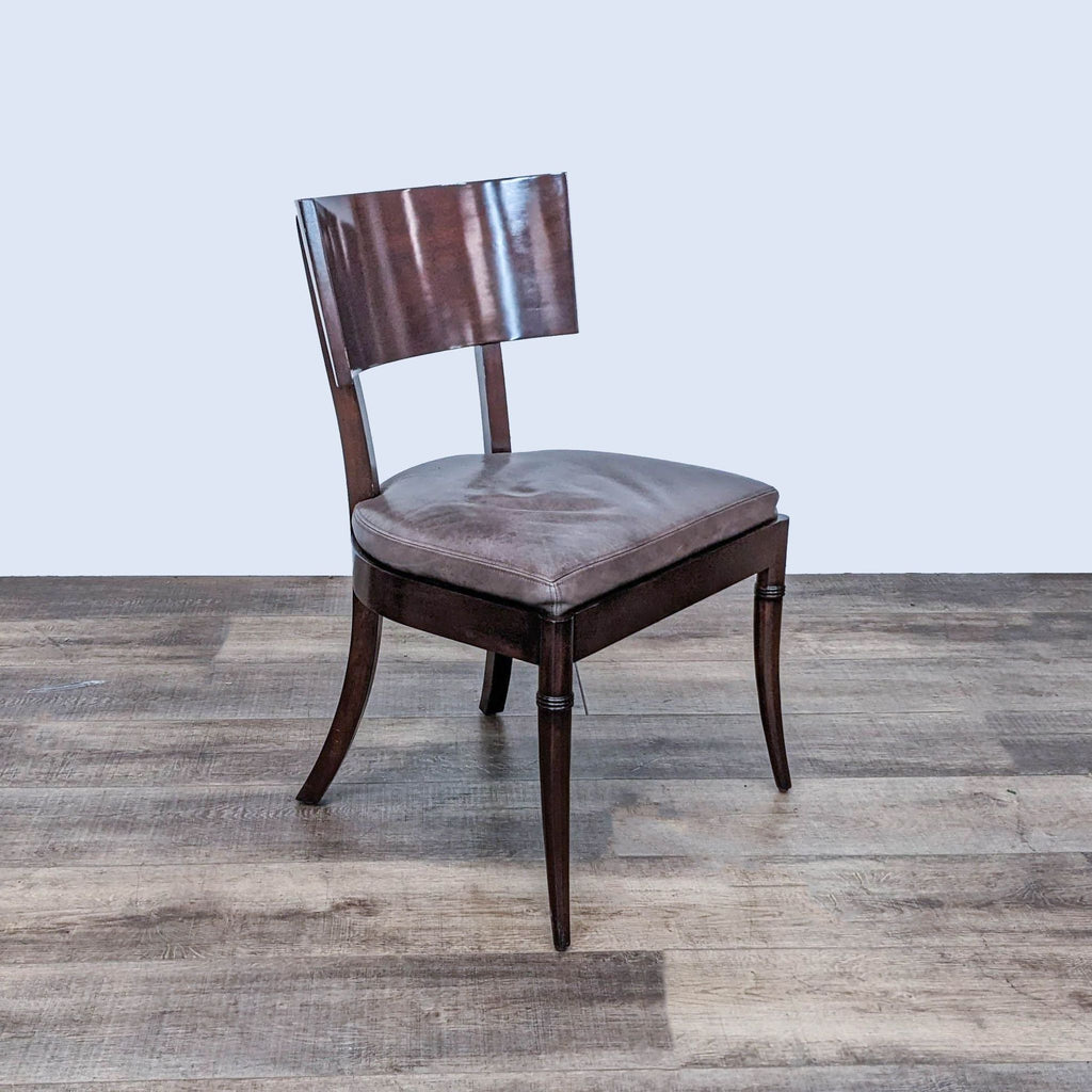 Angled view of the Williams Sonoma Home dining chair showing wood and leather detailing.