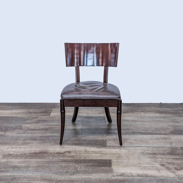 Front view of a Williams Sonoma Home dining chair with wood scoop back and leather seat.