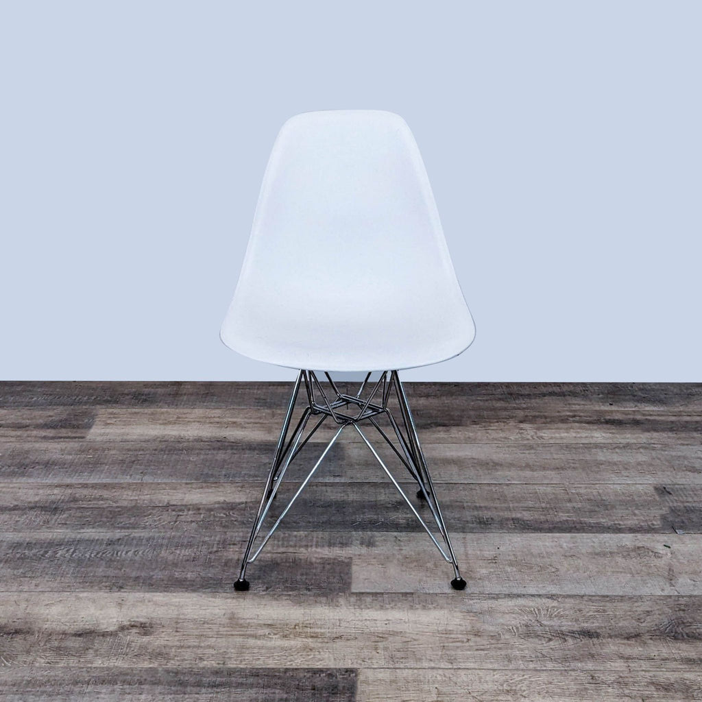 Eames dining chair with molded plastic seat and chrome Eiffel base.