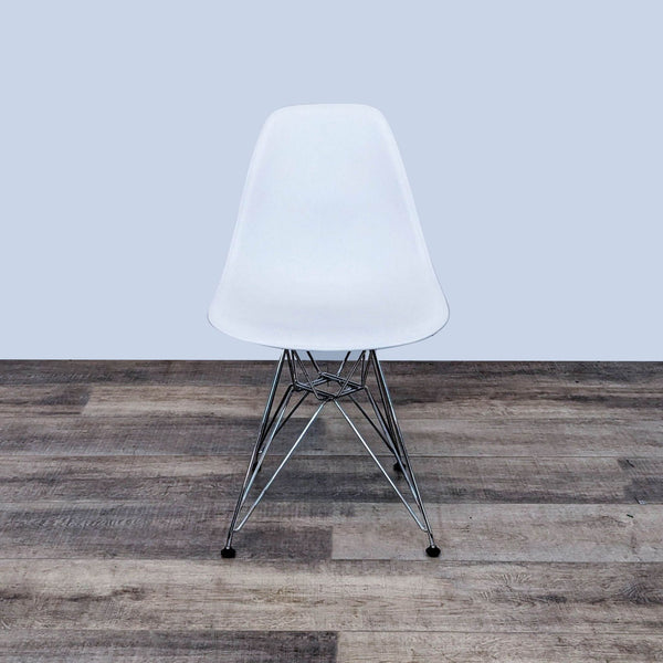 Eames dining chair with molded plastic seat and chrome Eiffel base.