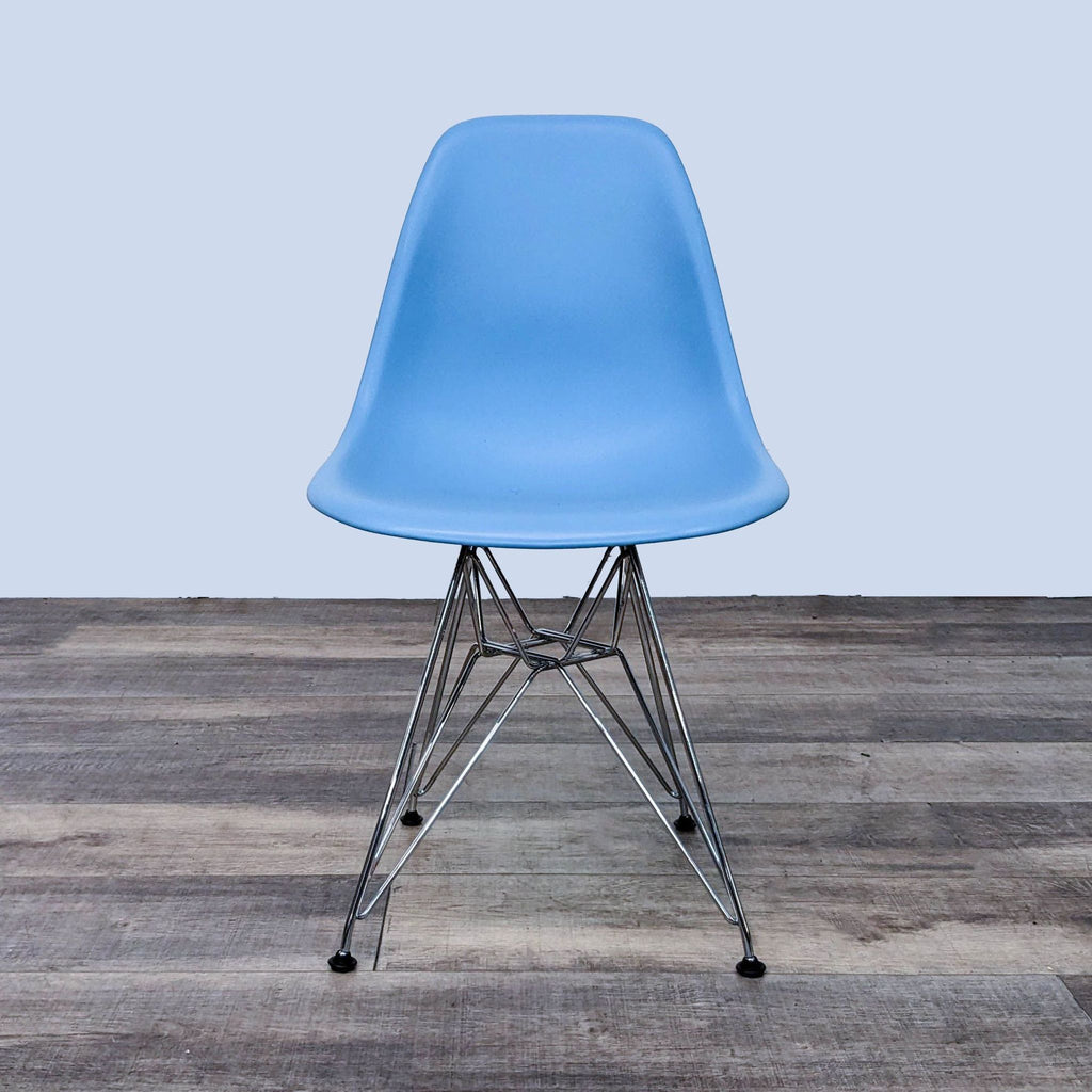 Front view of a blue Eames dining chair with chrome Eiffel base by Herman Miller.