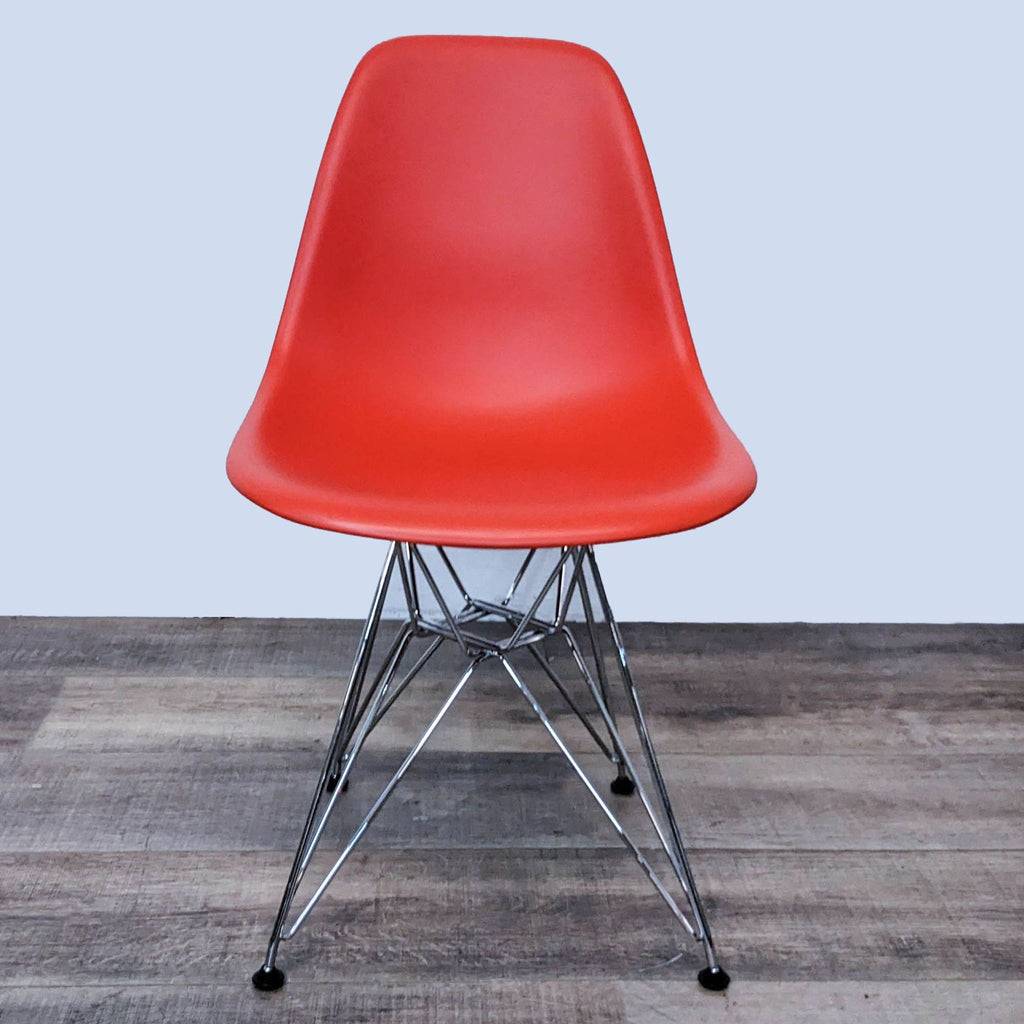 Red Eames dining chair with Eiffel base and molded plastic seat.  