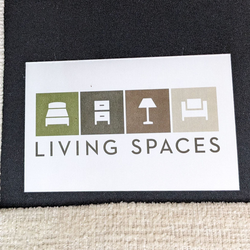 3. Living Spaces brand label featuring furniture icons, attached to a light fabric surface.