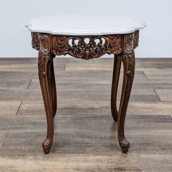 Scalloped marble-topped end table with carved wood base by Reperch.