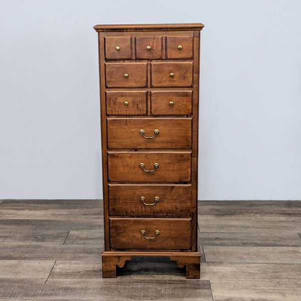 Traditional highboy dresser with seven drawers and brass handles in natural wood finish.
