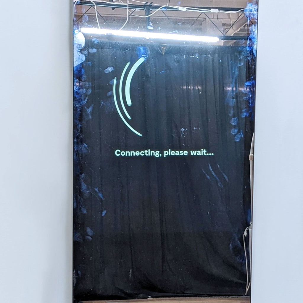 Close-up of Lululemon Studio Mirror with a connecting message and reflection of ceiling lights.  