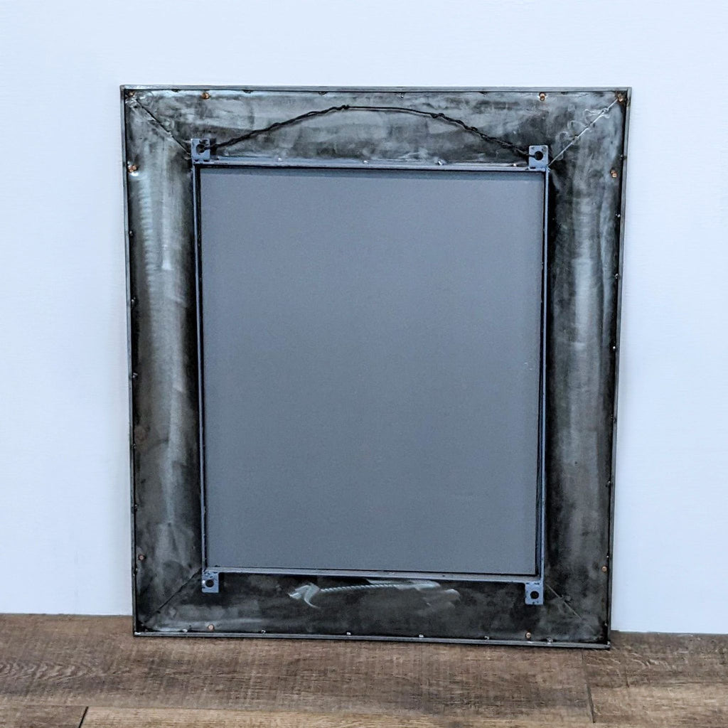 a vintage metal framed mirror with a metal frame.