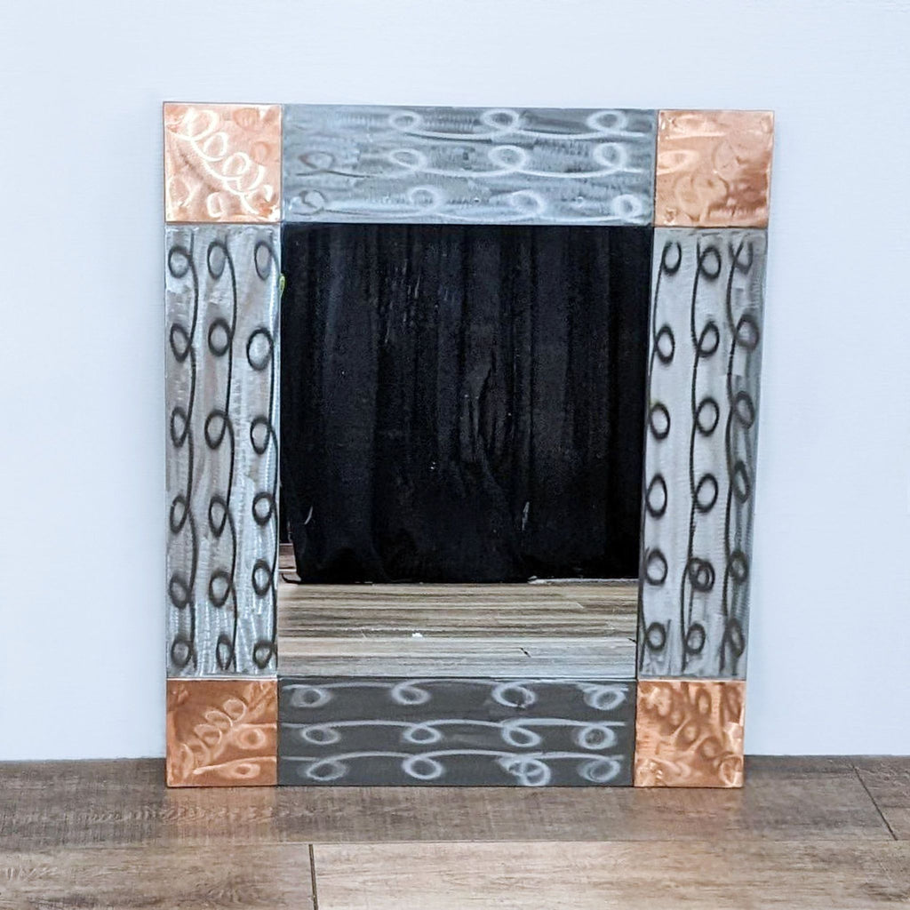a large mirror with a metal frame and a black background.