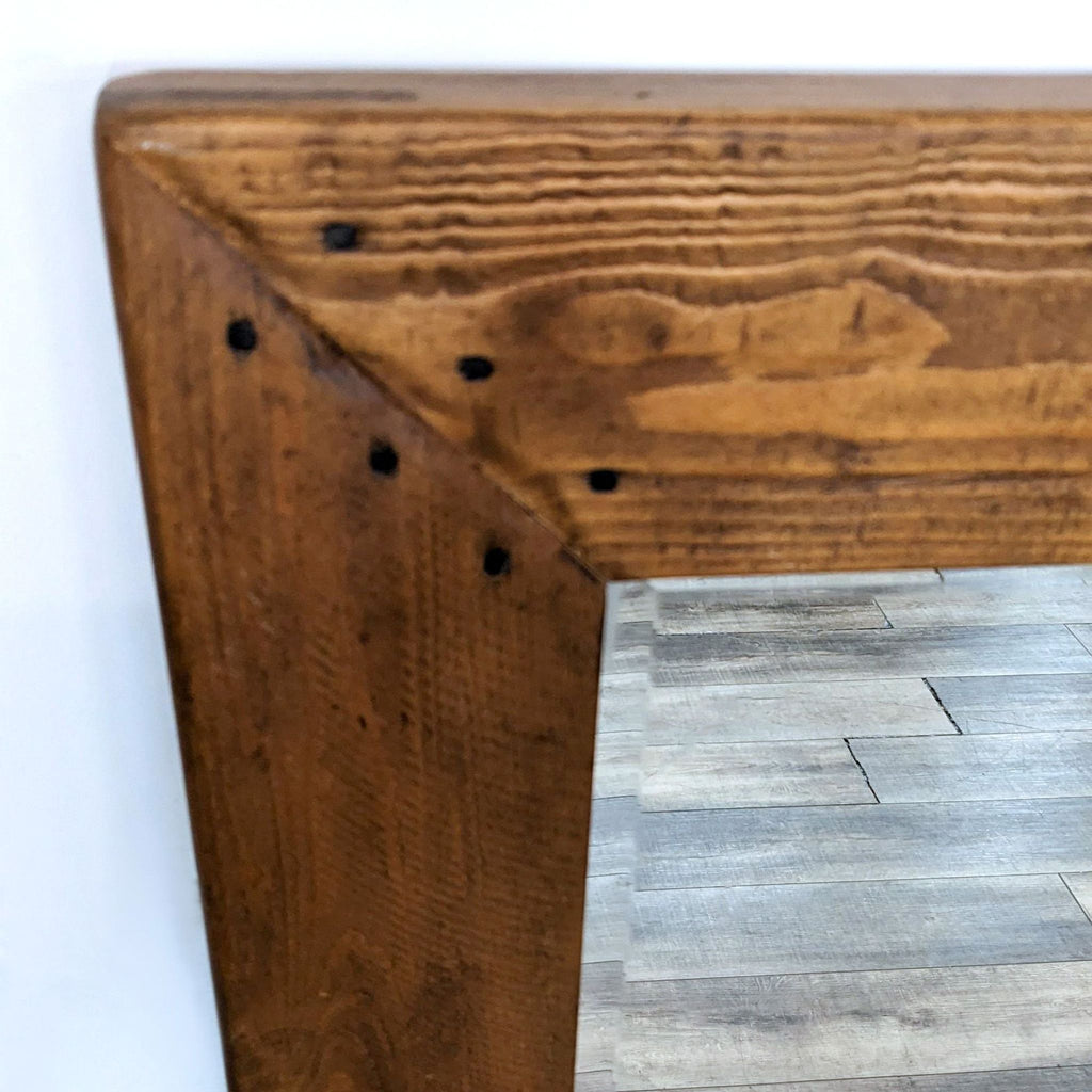 Close-up of rustic wood frame on a Pottery Barn mirror.