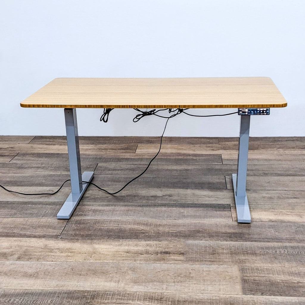 a desk with a computer monitor and a power cord.