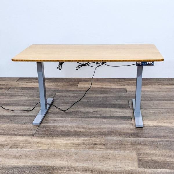 a desk with a computer monitor and a power cord.