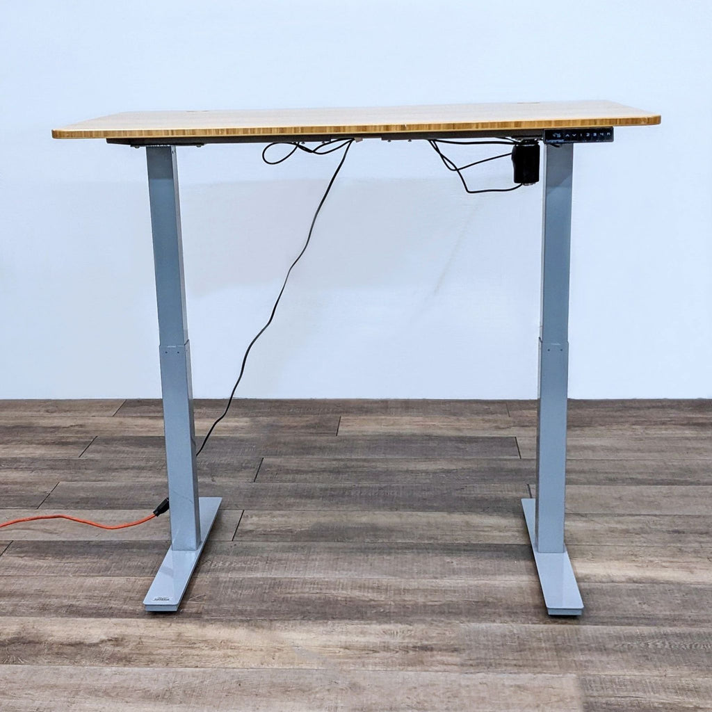 Height-adjustable desk with bamboo top and gray steel frame by Autonomous.