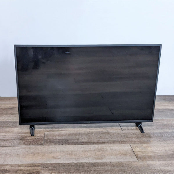 Front view of an Insignia Fire TV showing its sleek design and black frame.