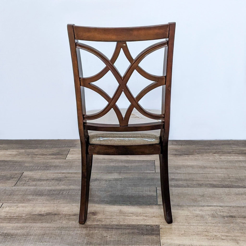 Back view of dining chair highlighting lattice design in dark wood.