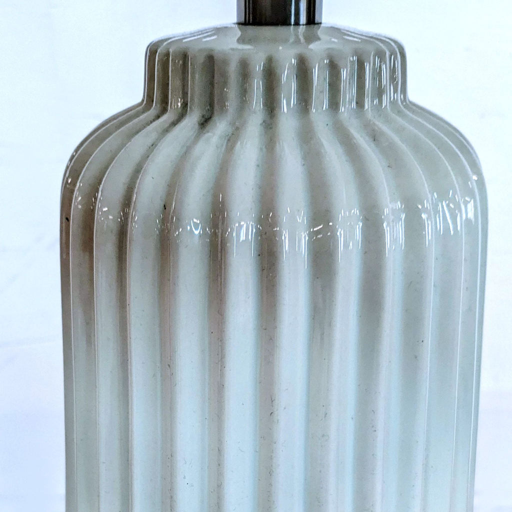 Close-up of the Reperch lamp's ribbed ceramic base design.