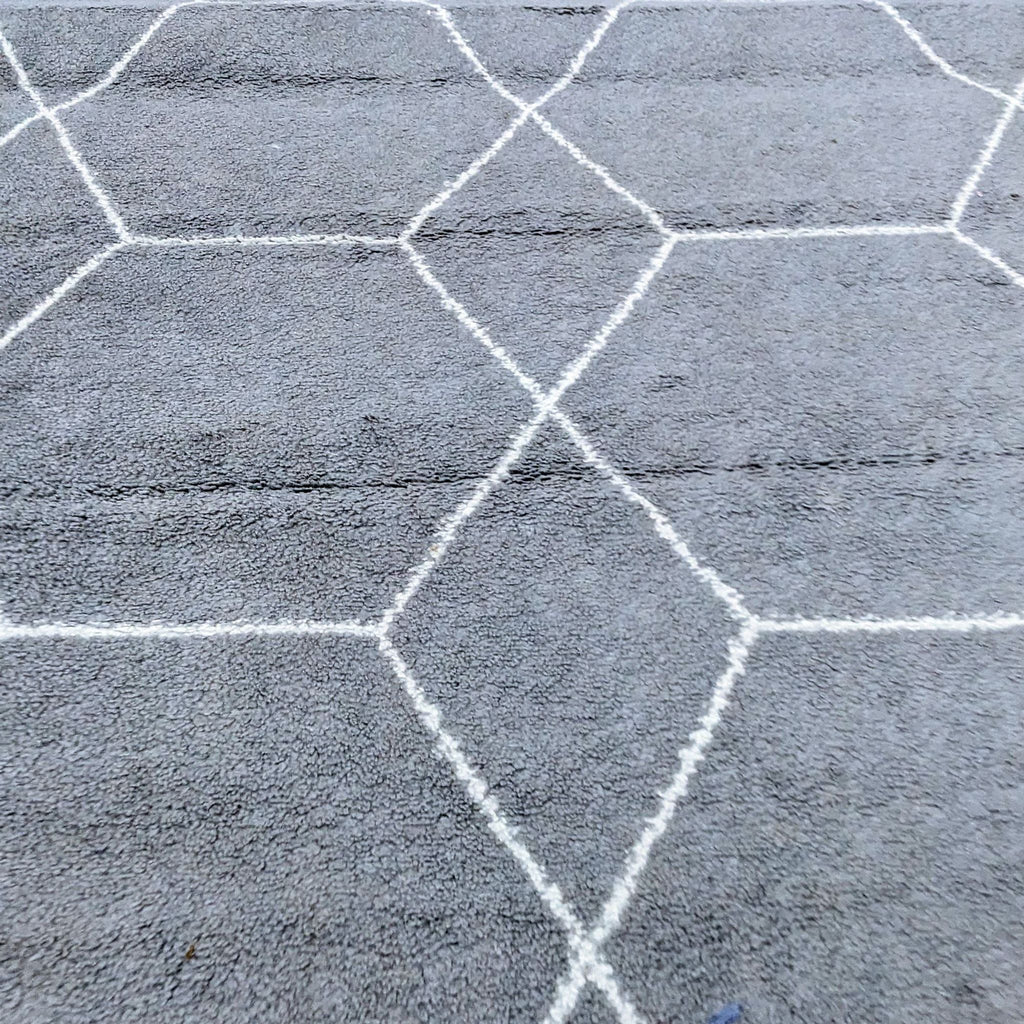 a grey carpet with a hexagon pattern on it.