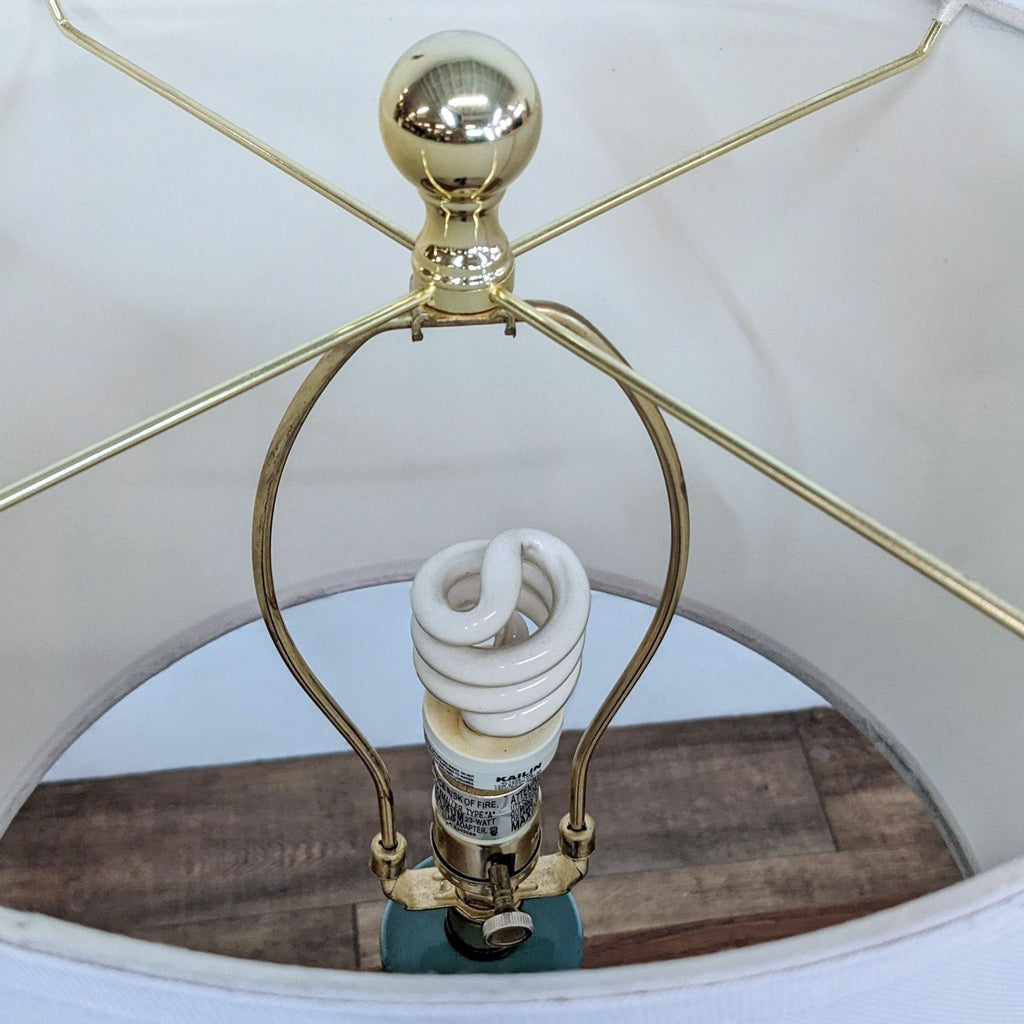 Close-up of lamp bulb inside a white shade.