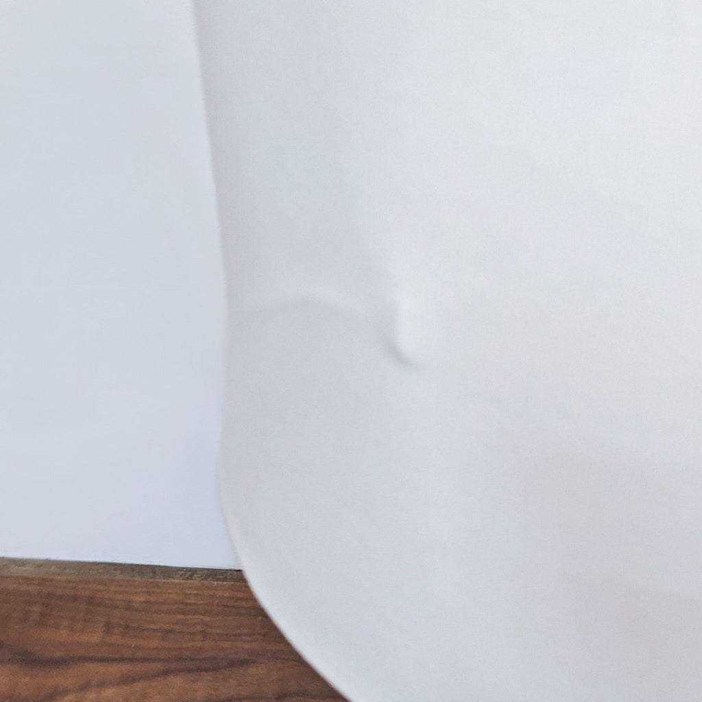 Close-up of white lampshade showing slight indentation.  