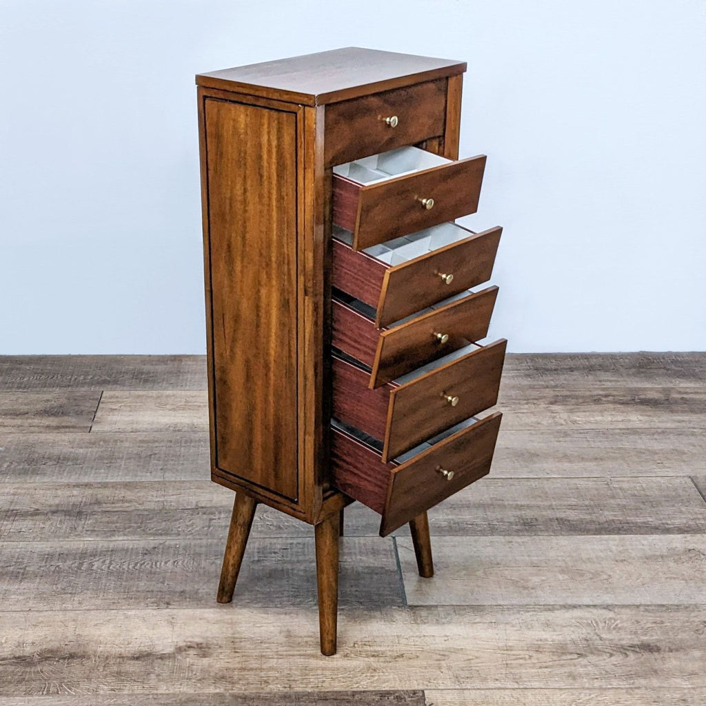 Open drawer view of a vintage-style jewelry chest, highlighting storage features and brass knobs.