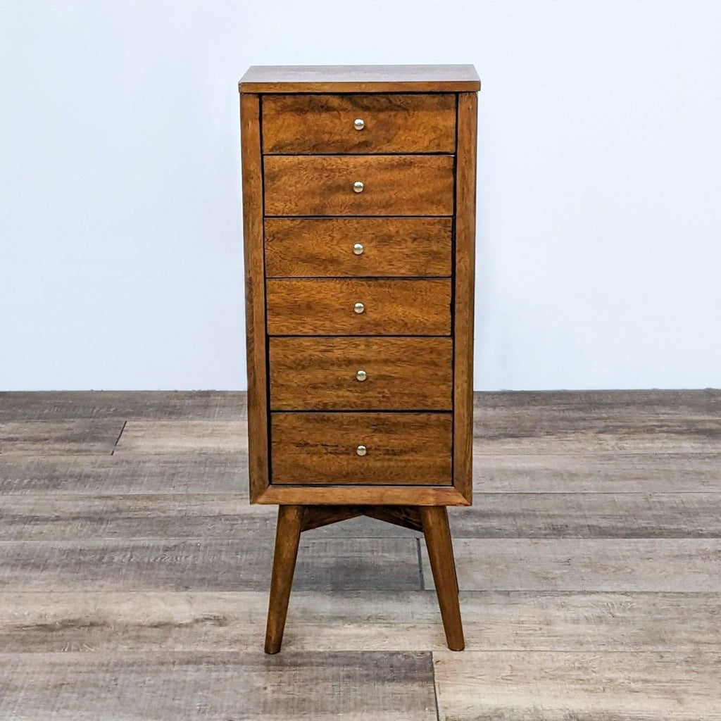 Vintage-style jewelry chest with five drawers and classic brass knobs on sleek legs.
