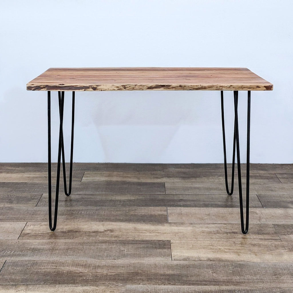 Rustic dining table with natural wood top and hairpin legs by Reperch.