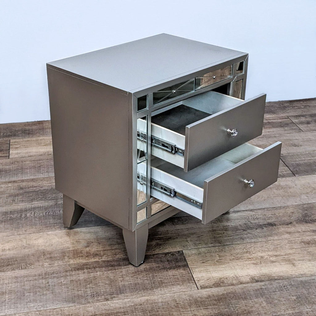 Two-drawer nightstand with mirrored accents and angled legs in a metallic mercury finish.