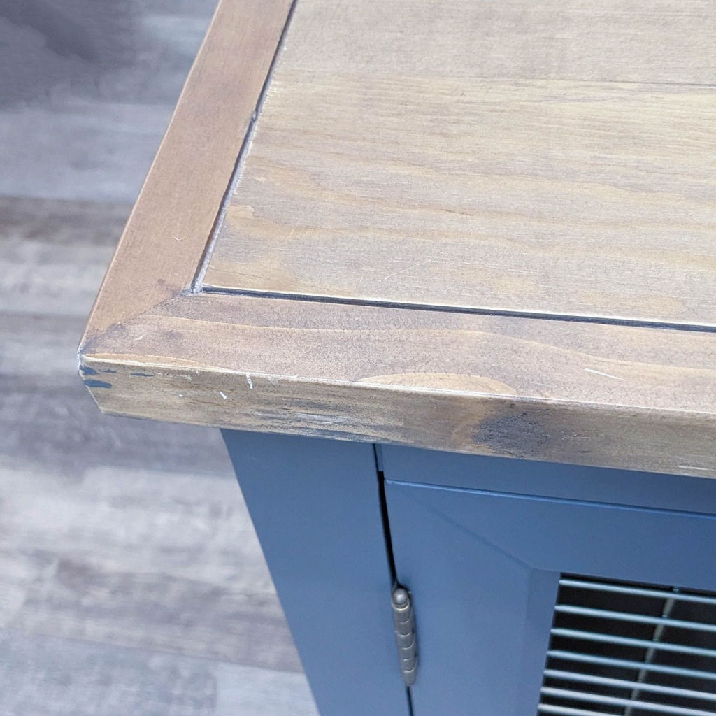 Close-up of the wood top on a Reperch metal cabinet.