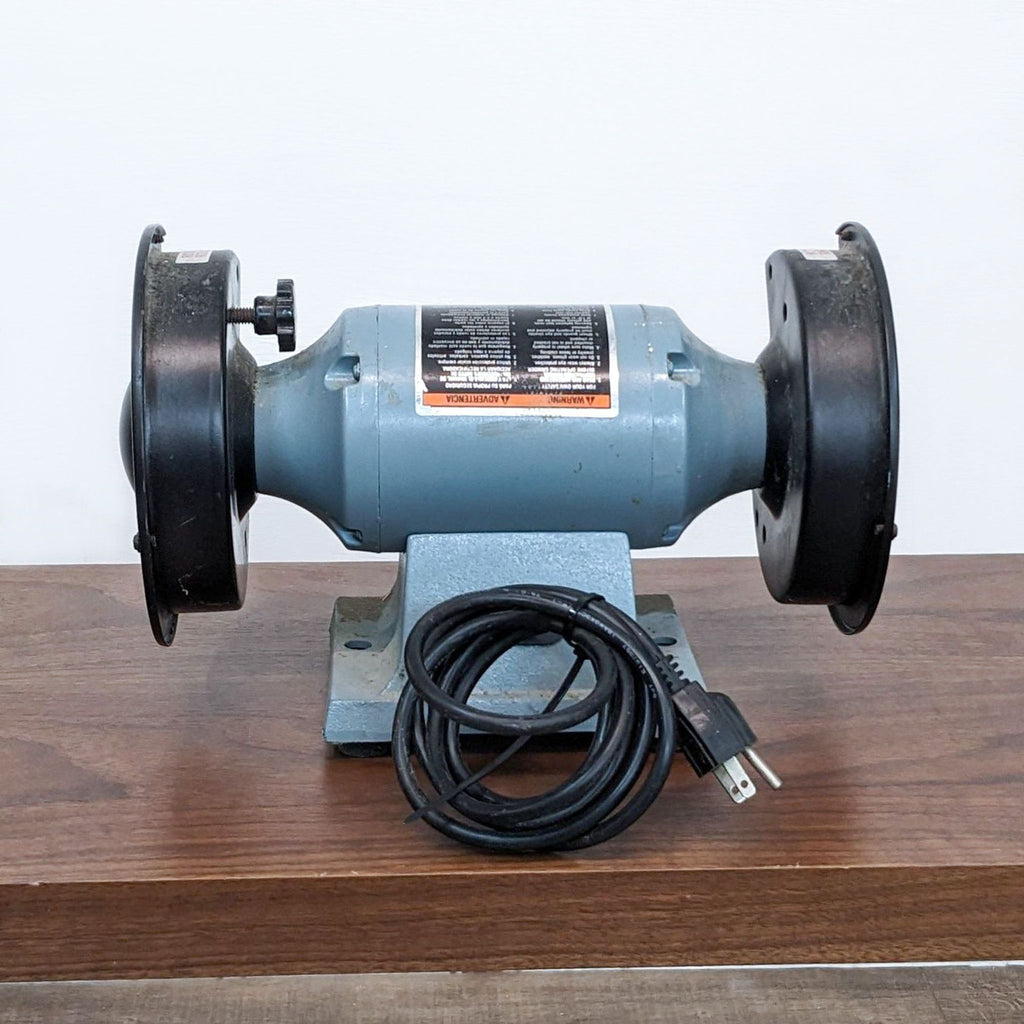 Delta 6" Thin-Line Bench Grinder, Model 23-660, with two grinding wheels on a wooden surface.