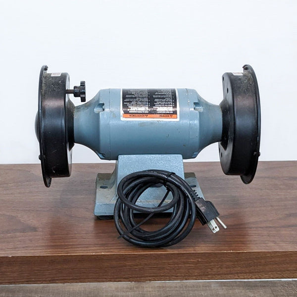 Delta 6" Thin-Line Bench Grinder, Model 23-660, with two grinding wheels on a wooden surface.