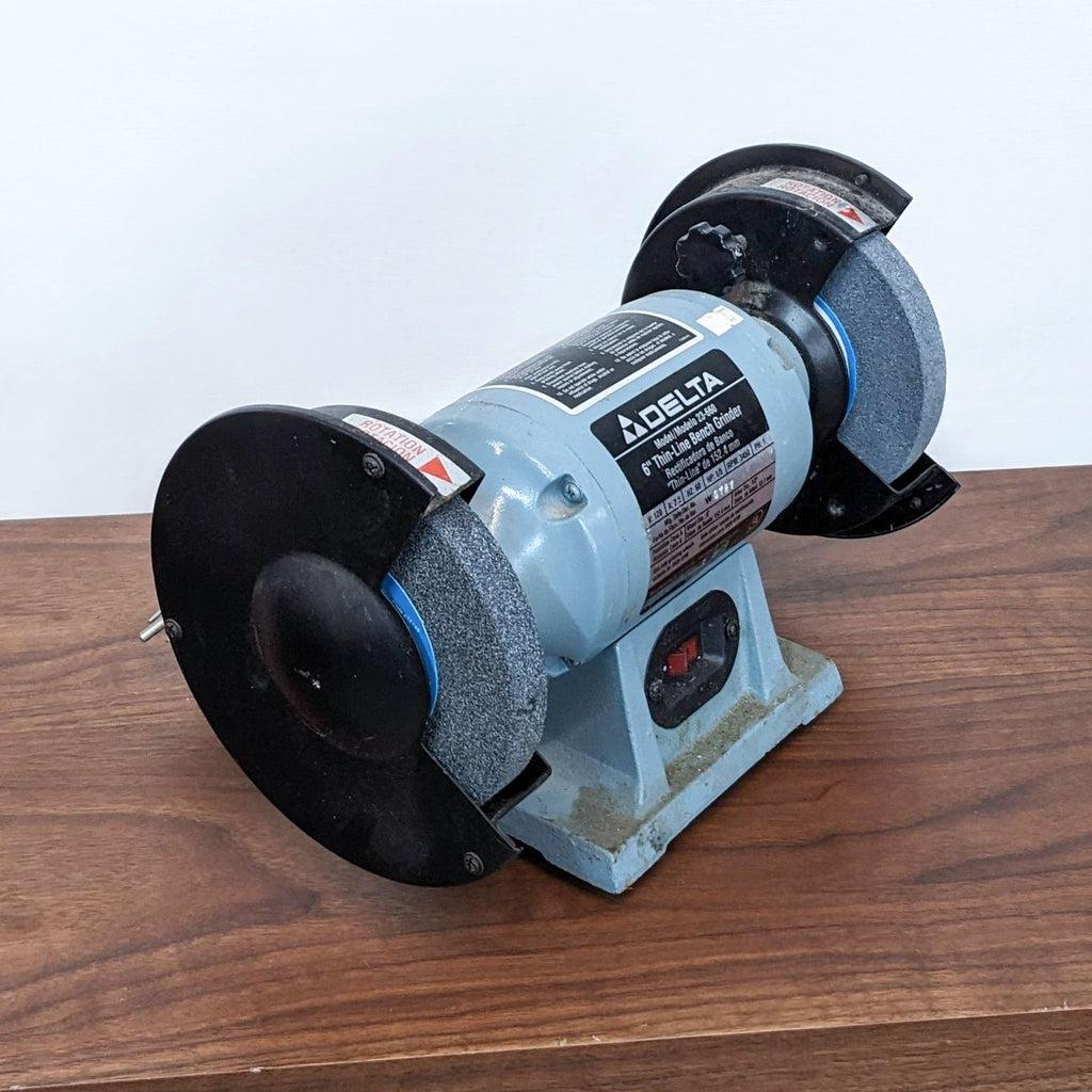 Close-up of Delta bench grinder, showing model details and specifications on the front label.