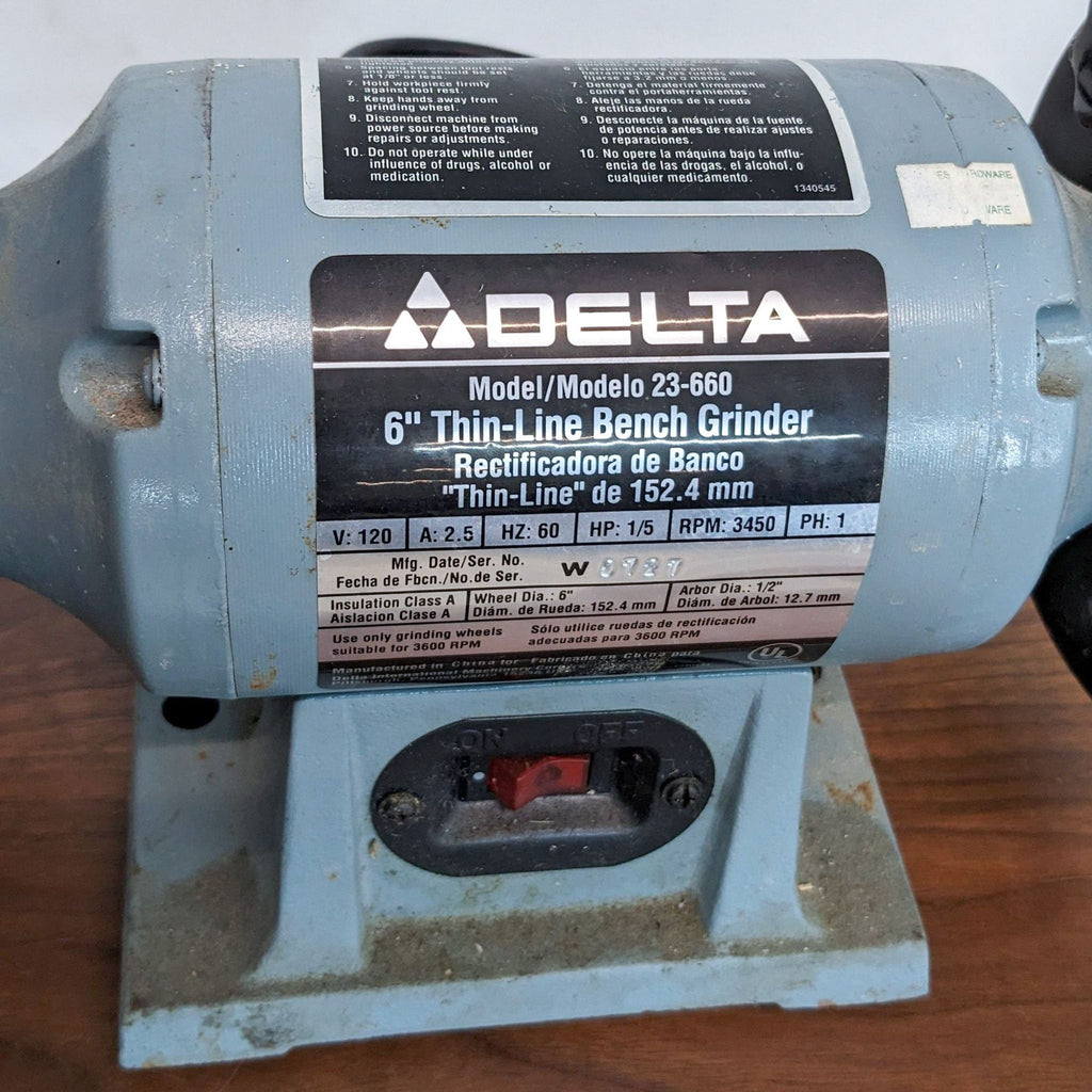 Side view of Delta bench grinder with visible grinding wheels and on/off switch.