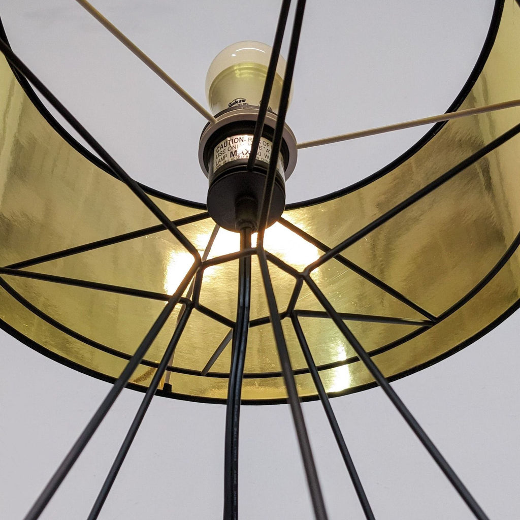 Close-up view of a light bulb and golden interior within a geometric wireframe lamp.