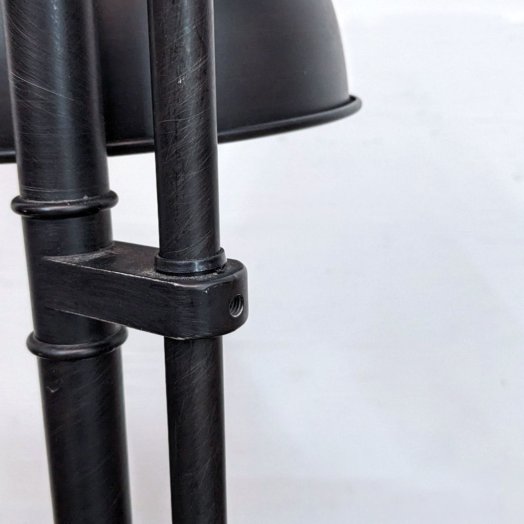Close-up of the black metal adjustable hinge on Reperch lamp.