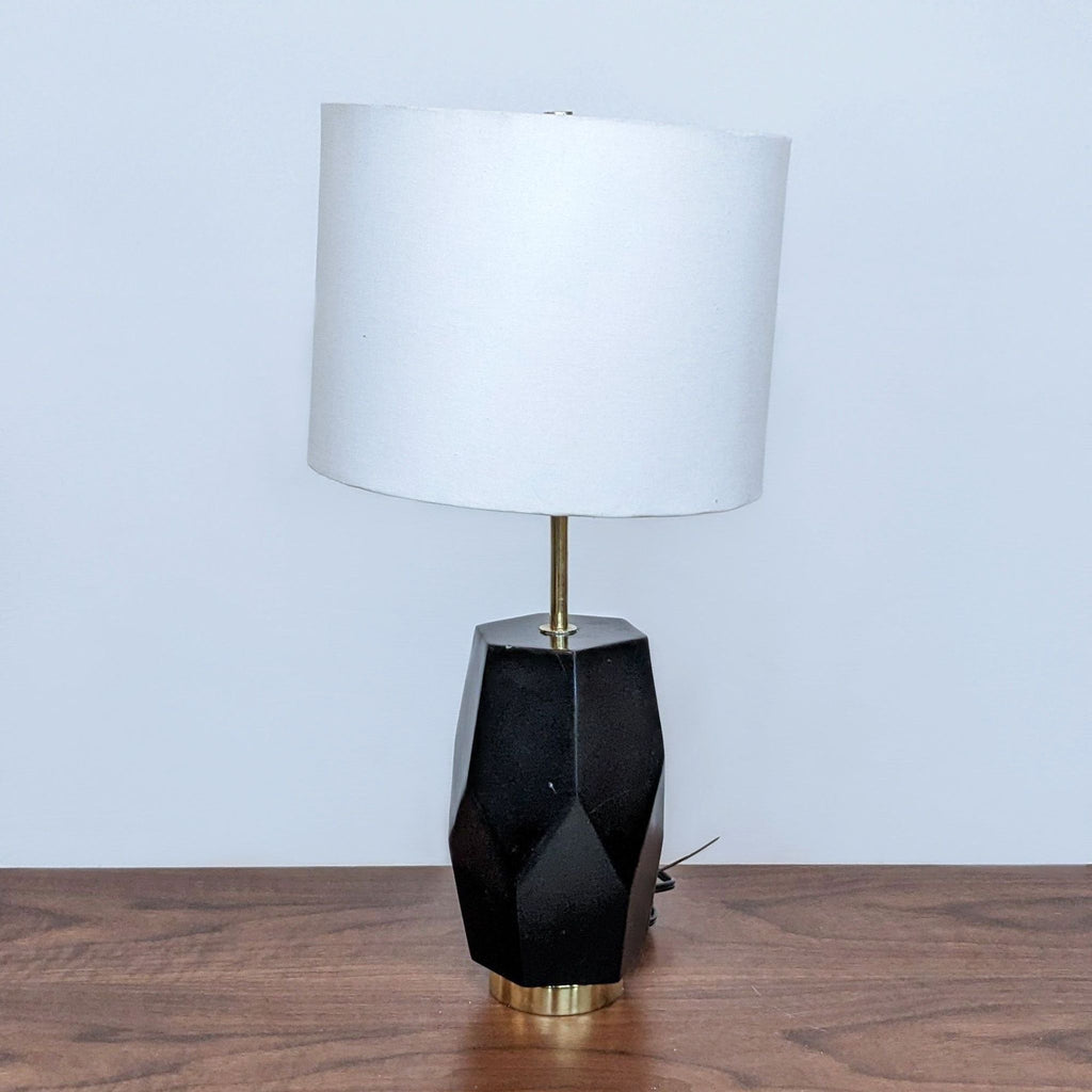 Stylish Reperch table lamp featuring a black geometric base and a white drum shade.