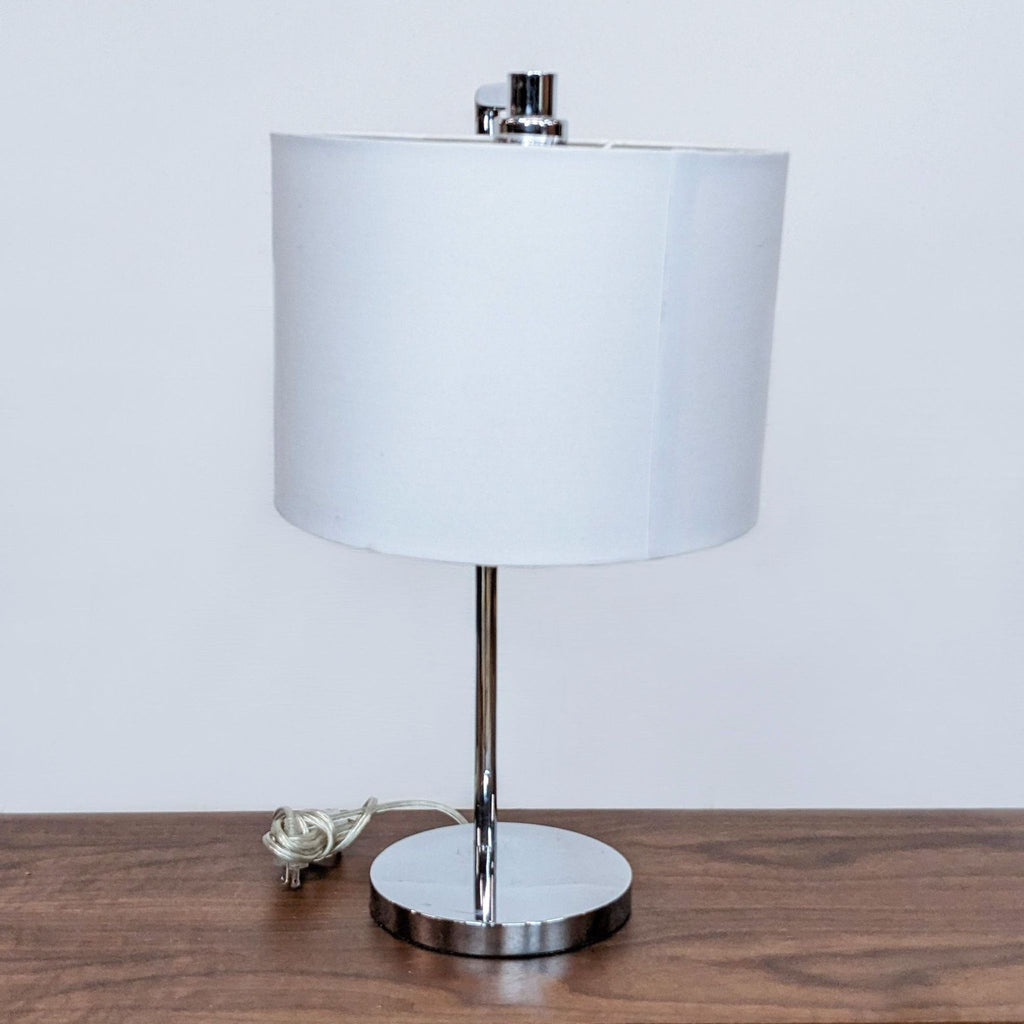 Side view of Reperch lamp showing white drum shade and cord.