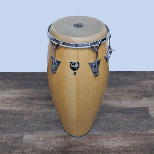 Pair of wooden conga drums with natural skin heads and chrome hardware.
