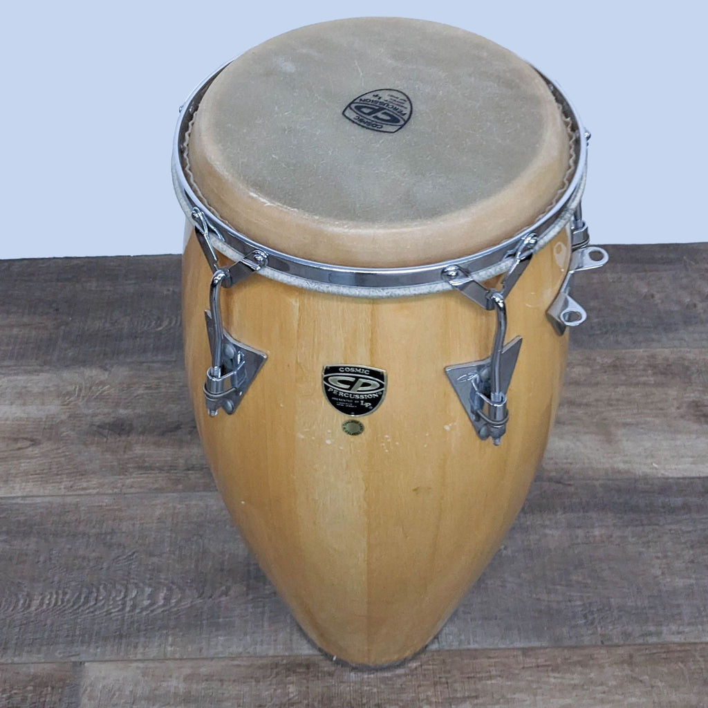 Wooden conga drum with Cosmic Percussion brand logo and chrome components.