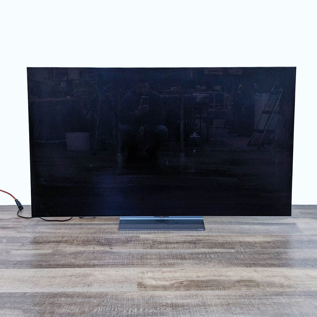 LG OLED evo C3 TV in standby mode with a reflective dark screen.