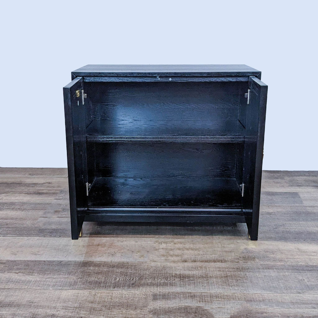 Open black cabinet showing two adjustable shelves inside.