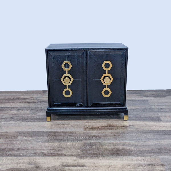 Black cabinet with antiqued brass sculpted handles by Johnathan Adler.