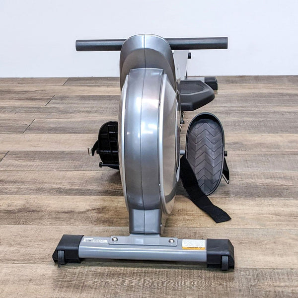 1. Silver Sunny rowing machine on wooden floor, viewed from the side.