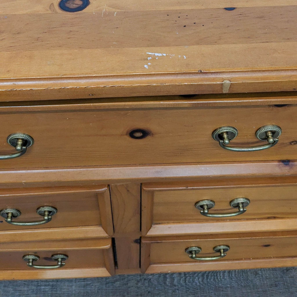 Close-up of the Reperch dresser’s surface with antique-style handles.