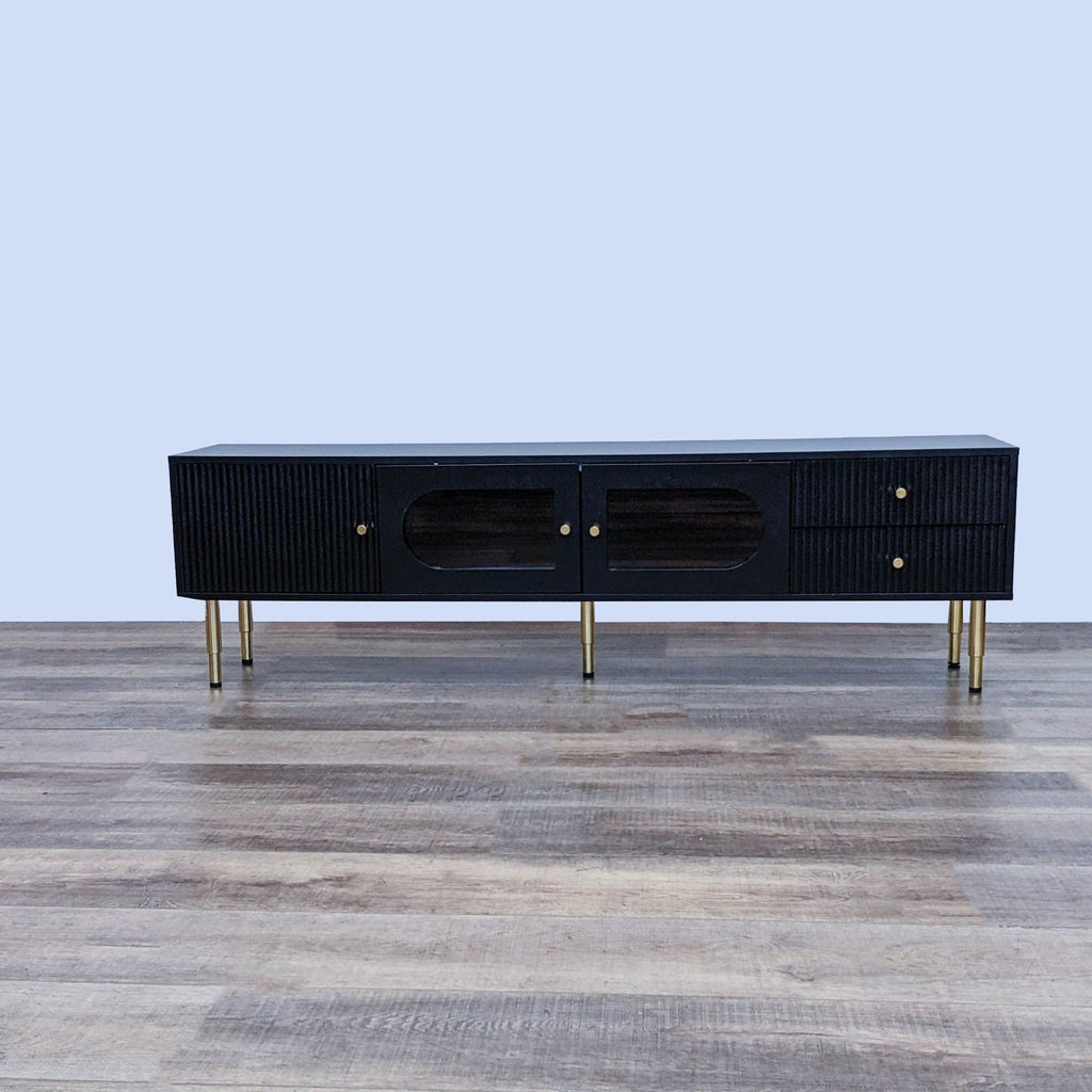 Sleek TV stand with striped panels, frosted glass doors, and gold metal accents.