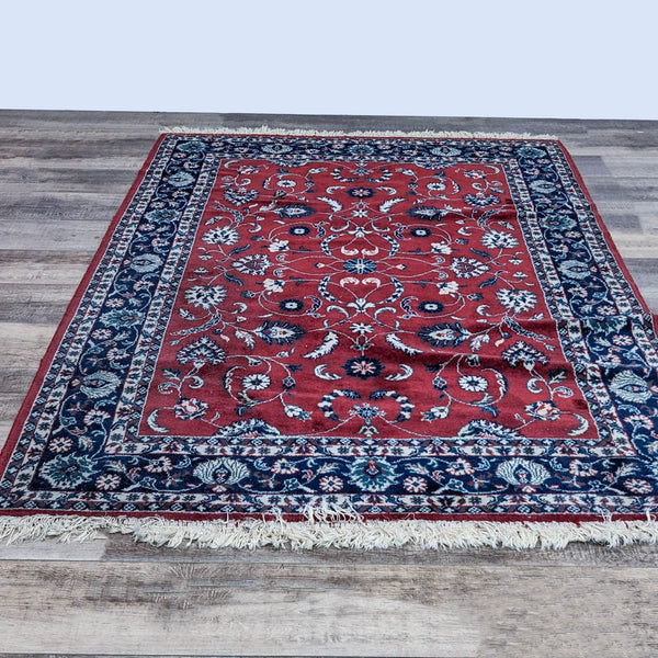 Red and blue oriental wool rug with intricate floral patterns by Reperch, size 5'7" x 8'4".  