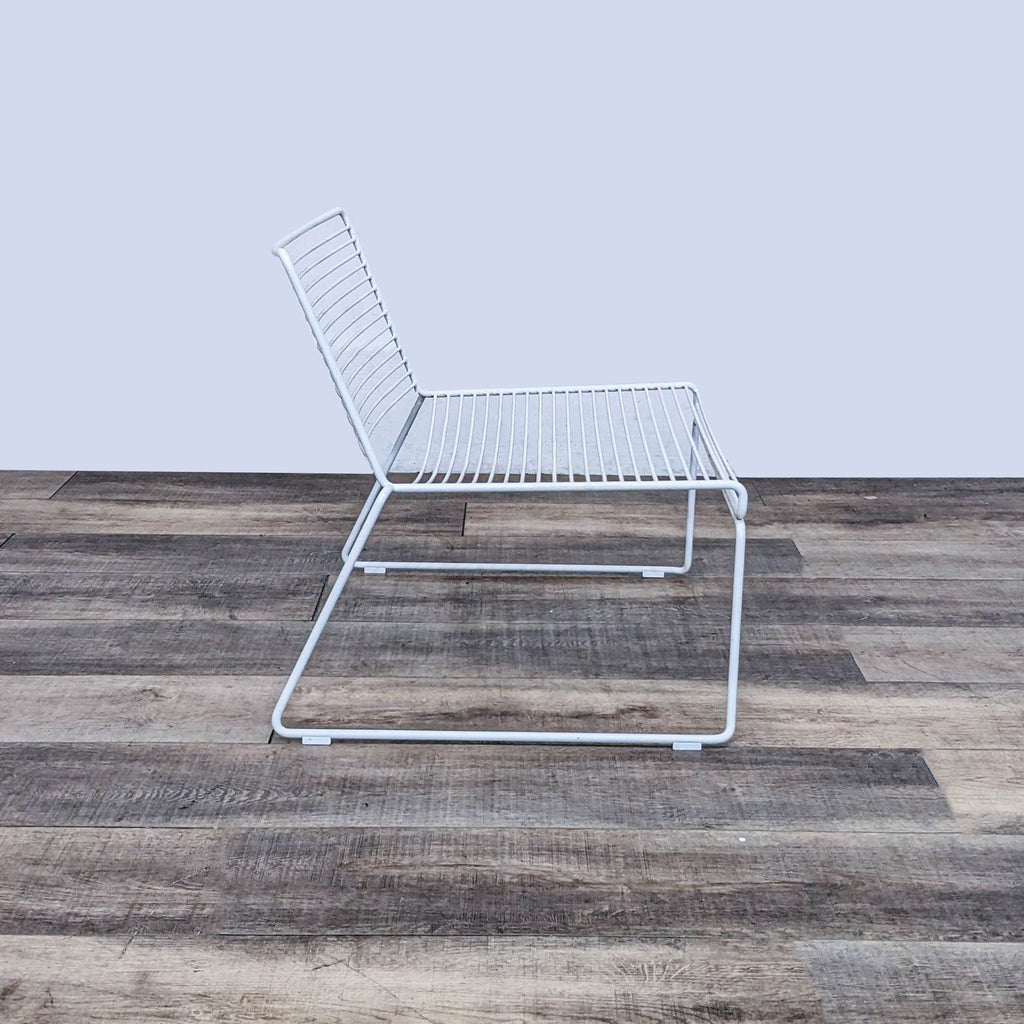 Angled view of Hee Modern Lounge Chair with minimalist design and durable steel construction.