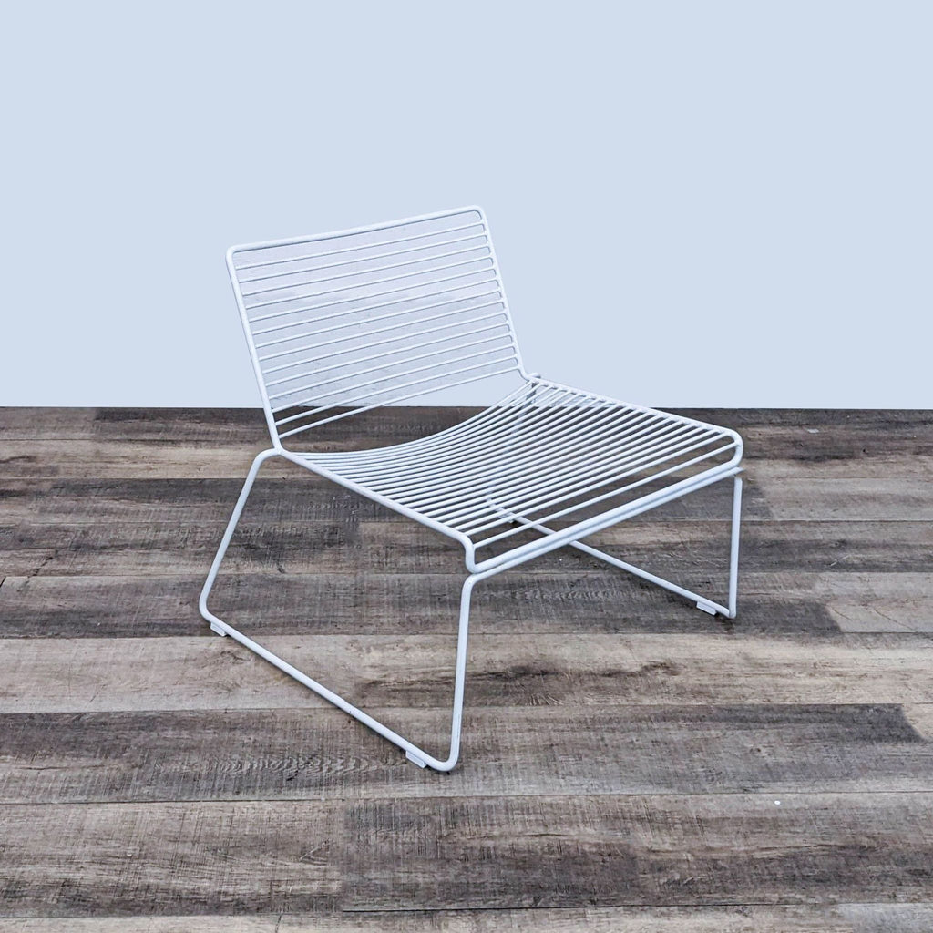 Side view of Hee Modern Lounge Chair, highlighting its stackable design and sturdy frame.