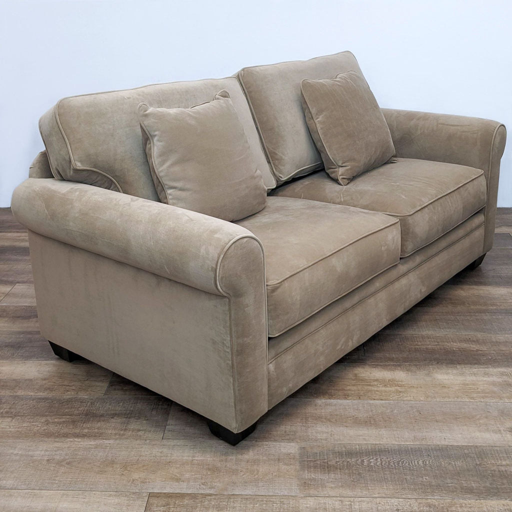 2. Contemporary 3-seat Reperch sofa featuring soft fabric, rolled arms, and T back cushions, angled side view.