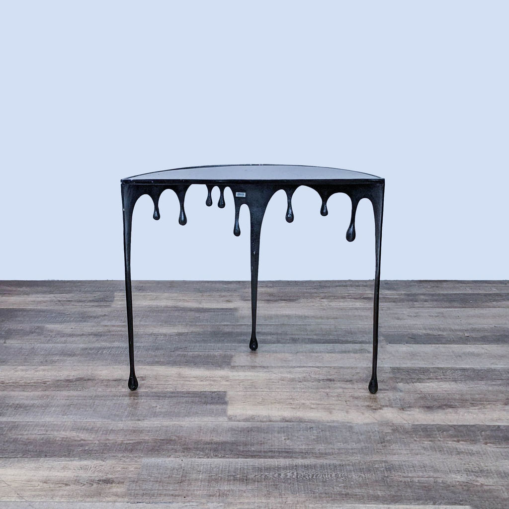 Artistic Reperch side table with melting effect, standing on wooden flooring. 